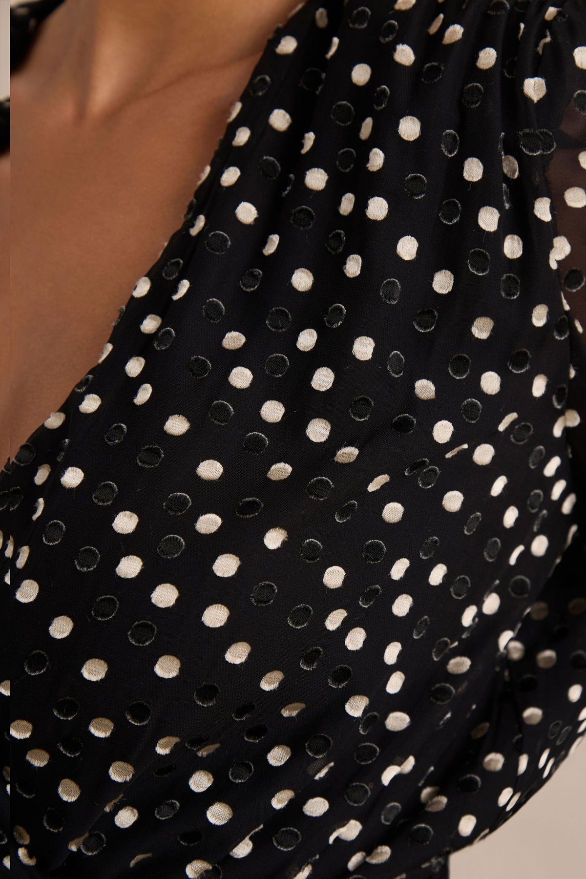 Mela | Vestido corto negro y blanco de lunares con escote pronunciado, mangas campana y Fajín