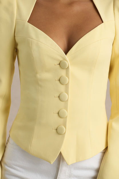 Olympia | Top de manga larga amarillo con escote corazón y detalle de botones forrados