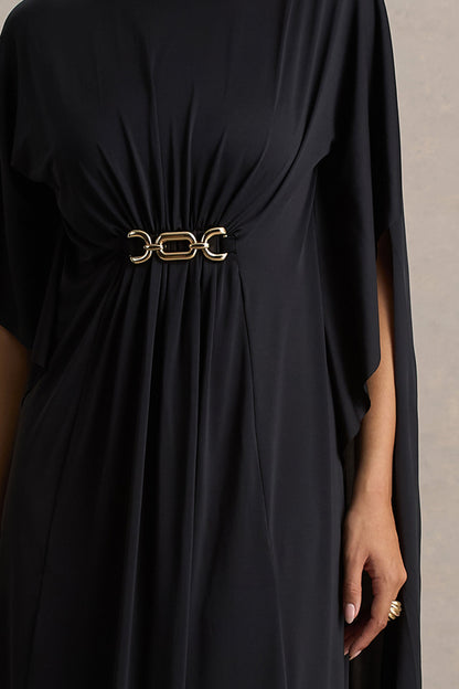 Olessia | Vestido negro con mangas tipo capa y cinturón con detalles dorados